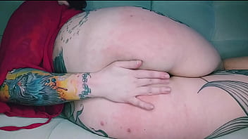 Tattooed hottie with a big ass takes her panties in her mouth and slaps her fucking ass