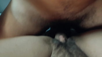 Missionary position with cock starting to get an erection he rubs his penis on the hairy pussy
