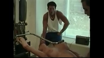 Blonde fucked by two males in the gym