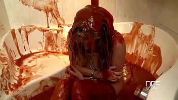 Chained babe peeing & bathing in red juice