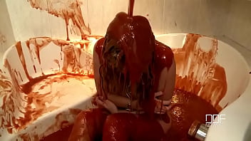Chained babe peeing & bathing in red juice Chained babe peeing & bathing in red juice