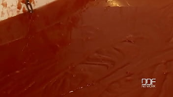 Chained babe peeing & bathing in red juice Chained babe peeing & bathing in red juice