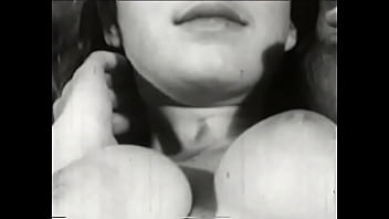 Busty beauty with dark hair caresses her beautiful tits in bed