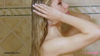Radiant blonde beauty enjoys a sensual bath