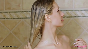 Radiant blonde beauty enjoys a sensual bath