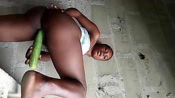 Black teen teasing pussy with a huge cucumber