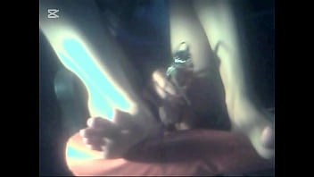 The camera under the table captured a beautiful woman at home alone and watching a porn movie