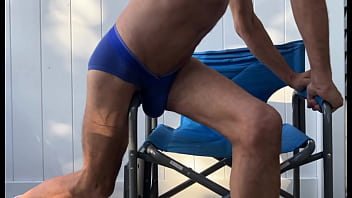 Deep pelvic stretching in blue briefs on blue chair late october 2024
