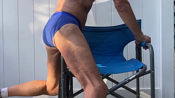 Deep pelvic stretching in blue briefs on blue chair late october 2024