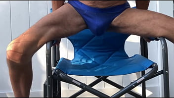 Deep pelvic stretching in blue briefs on blue chair late october 2024