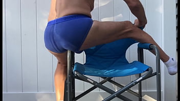 Deep pelvic stretching in blue briefs on blue chair late october 2024