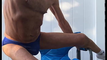 Deep pelvic stretching in blue briefs on blue chair late october 2024