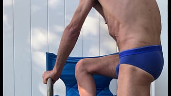 Deep pelvic stretching in blue briefs on blue chair late october 2024