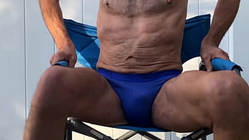 Deep pelvic stretching in blue briefs on blue chair late october 2024