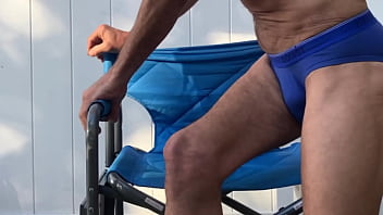 Deep pelvic stretching in blue briefs on blue chair late october 2024