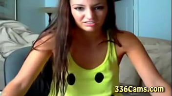 Sexy brunette teen with smile on yellow t shirt play on webcam