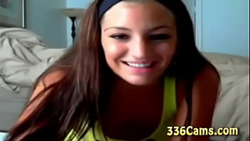 Sexy brunette teen with smile on yellow t shirt play on webcam