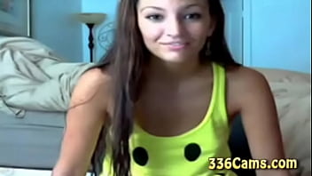 Sexy brunette teen with smile on yellow t shirt play on webcam