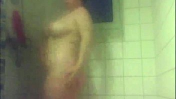 Chubby teen masturbates with shower head