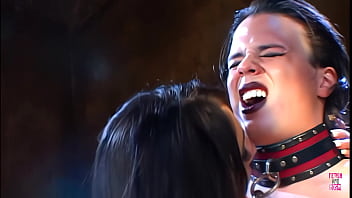 Two brunettes in leather attire engage