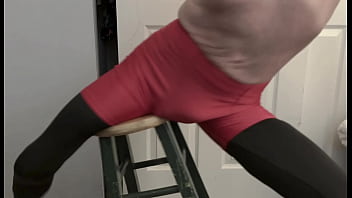 Grinding on stool in black compression tights and red compression shorts