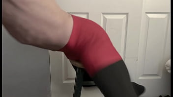 Grinding on stool in black compression tights and red compression shorts