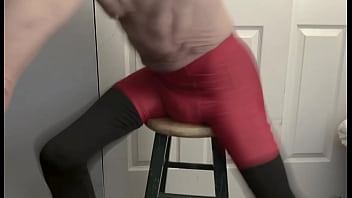 Grinding on stool in black compression tights and red compression shorts