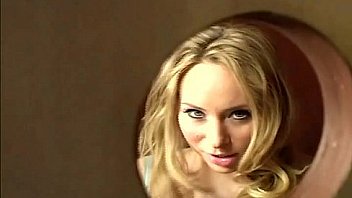 Sinful blonde sucks large dick peeping through glory hole