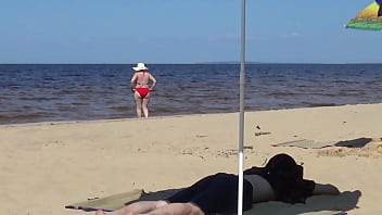 Nimble mature mommy has fun with young guys on the beach