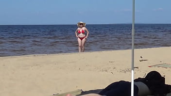 Nimble mature mommy has fun with young guys on the beach