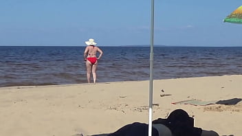 Nimble mature mommy has fun with young guys on the beach