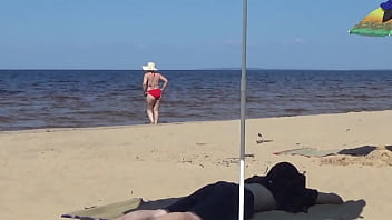 Nimble mature mommy has fun with young guys on the beach