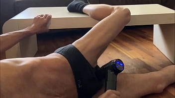 Preview of agressive myofascial pressure and release stretching on table in underwear with percussion massager