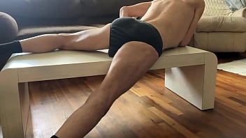 Preview of agressive myofascial pressure and release stretching on table in underwear with percussion massager
