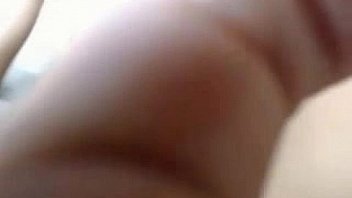 Busty brunette puts a dildo in her ass