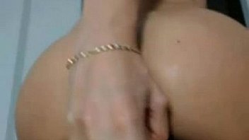 Busty brunette puts a dildo in her ass