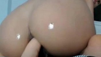 Busty brunette puts a dildo in her ass