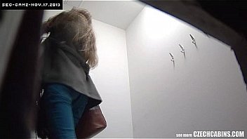 Nice brunette changing her bra in public store