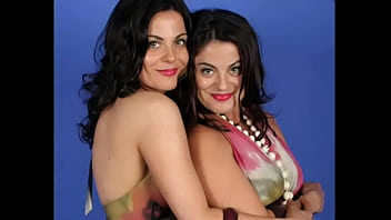 Identical lesbian twins posing together and showing all
