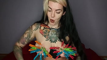 Tattooed kinky girl hangs the maximum number of clothespins on her big tits