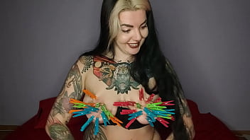 Tattooed kinky girl hangs the maximum number of clothespins on her big tits