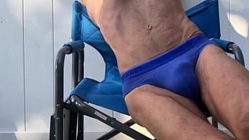Deep pelvic stretching in blue briefs on blue chair late october 2024