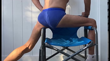 Deep pelvic stretching in blue briefs on blue chair late october 2024