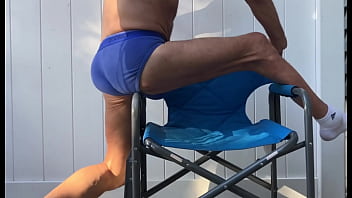Deep pelvic stretching in blue briefs on blue chair late october 2024