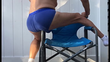 Deep pelvic stretching in blue briefs on blue chair late october 2024