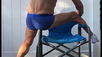 Deep pelvic stretching in blue briefs on blue chair late october 2024