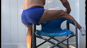 Deep pelvic stretching in blue briefs on blue chair late october 2024
