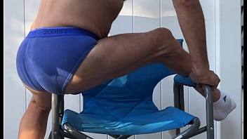 Deep pelvic stretching in blue briefs on blue chair late october 2024