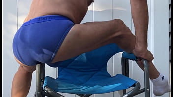 Deep pelvic stretching in blue briefs on blue chair late october 2024