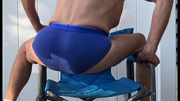 Deep pelvic stretching in blue briefs on blue chair late october 2024